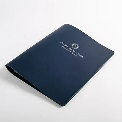 Personalised navy blue leather folder with logo and text embossed with silver foil in the cover.