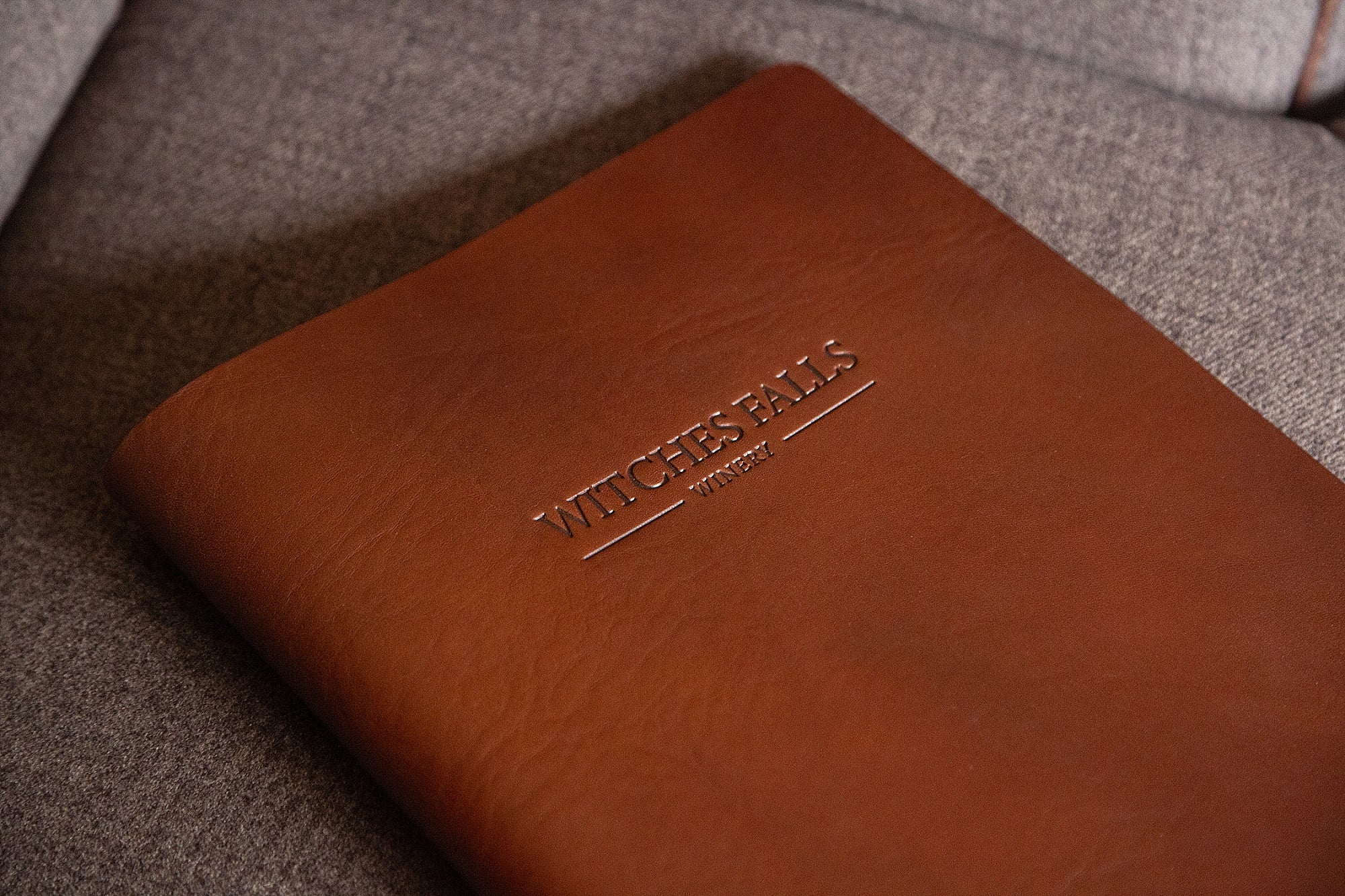 embossed logo on brown luxury leather menu cover