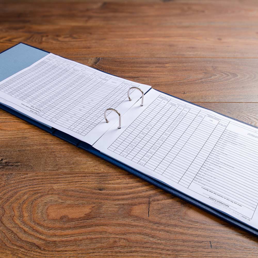 landscape ring binder lying open with printed pilot logbook sheets - Gallery image 3