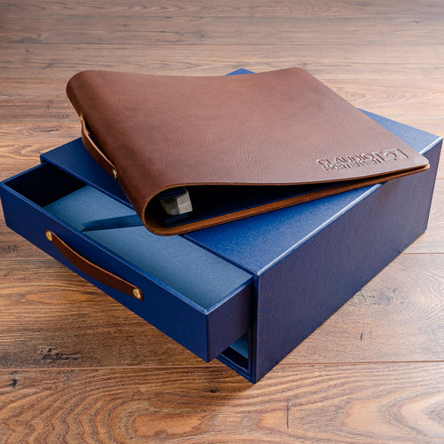brown leather photography portfolio book on blue drawer box slipcase