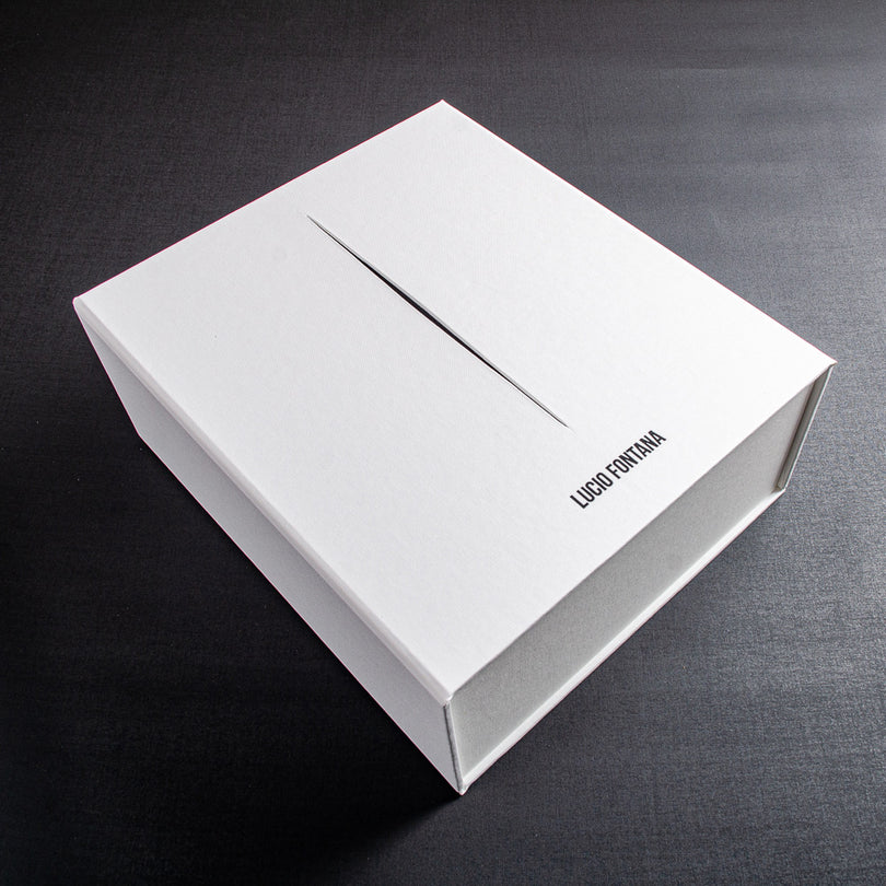 white clamshell box file with black cut out stripe and black foil embossed logo