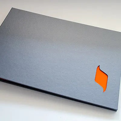 silver portfolio book with cut out window and orange cut out window