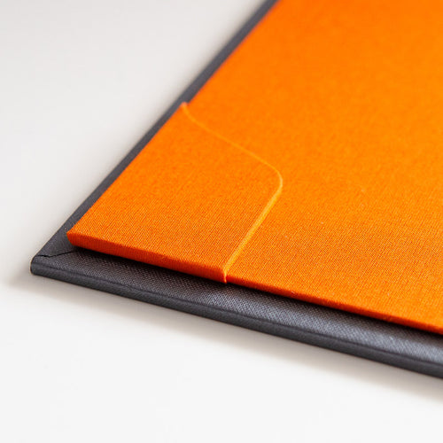 corner pocket on orange inner cover of luxury binder