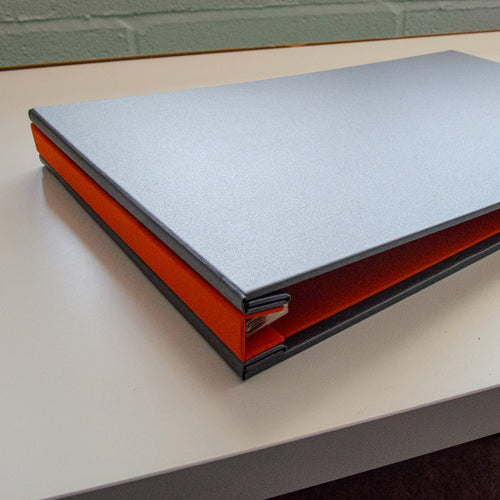 hidden screw post portfolio book in silver grey and orange fabric