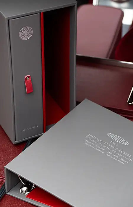 Custom made ring binder in grey with personalised cover and spine in silver foil for car history documents inside a jaguar car