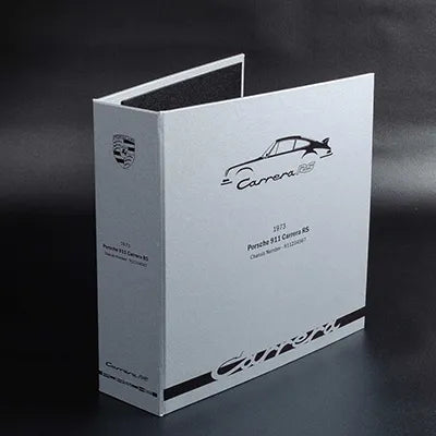 printed bespoke car history file in silver and black with titles and logos