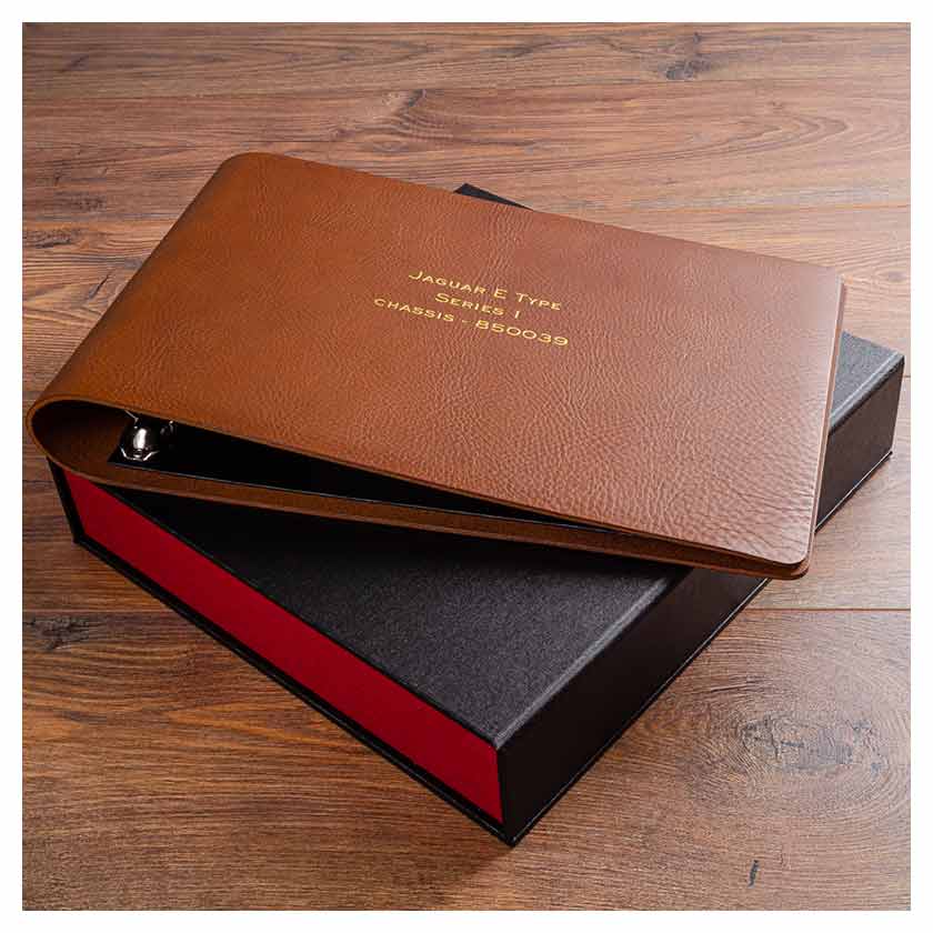 leather binder for classic car service and restoration history with personalised cover on top of clamshell storage box