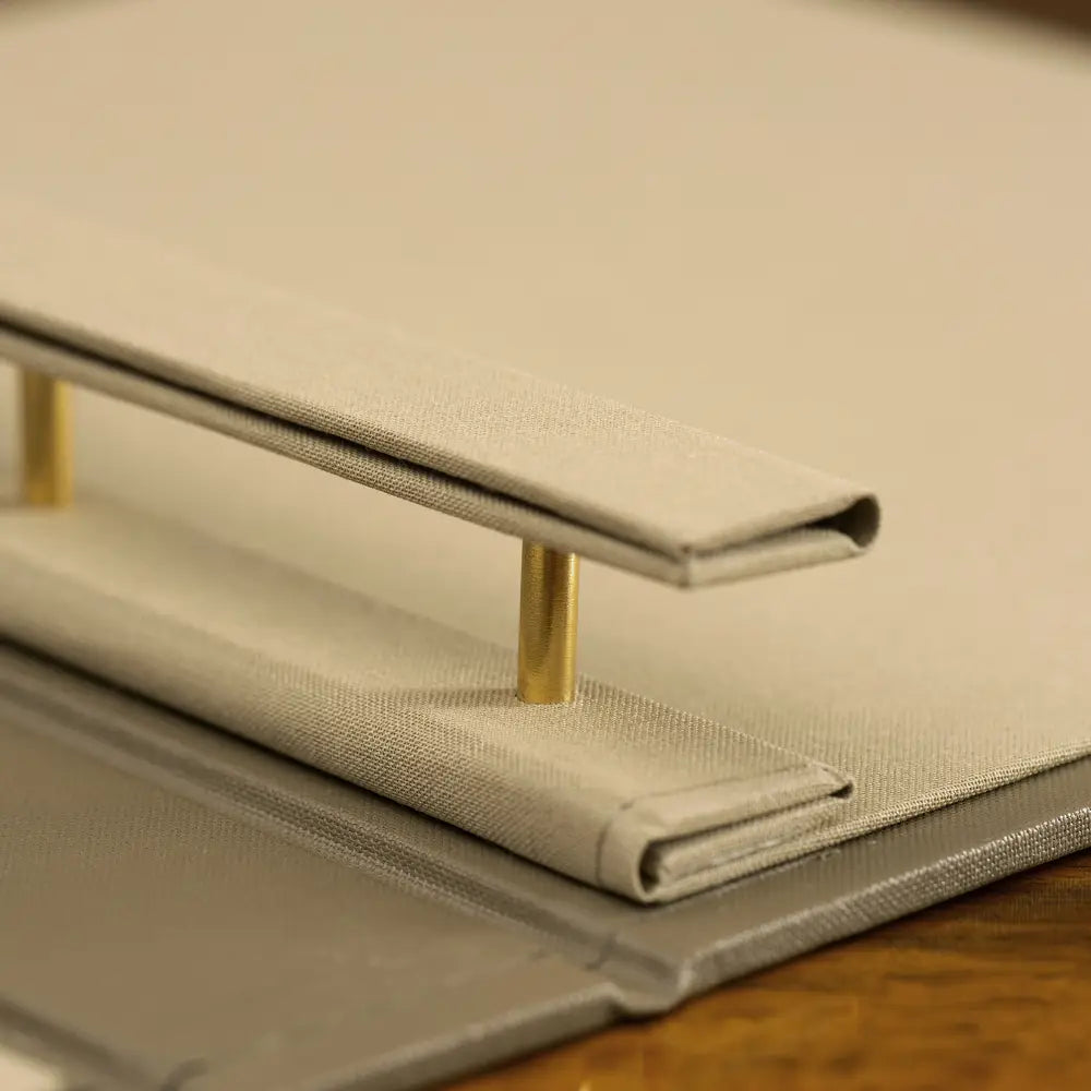 Detail of Case Bound Screw Post Binder in luxury fabric with gold screw post mechanism, bespoke and personalised portfolio binder by Hartnack and Company