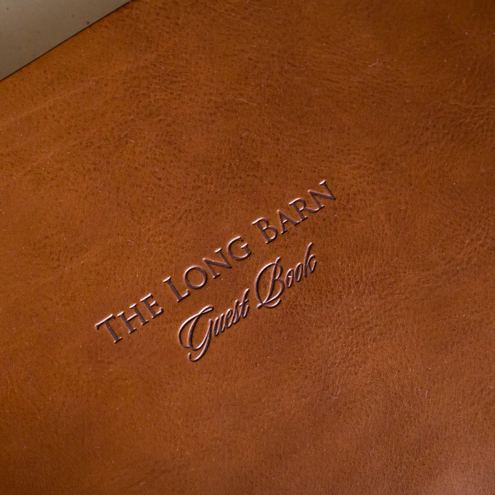personalized lettering and logo of a guest book on a brown leather cover - Gallery image 3