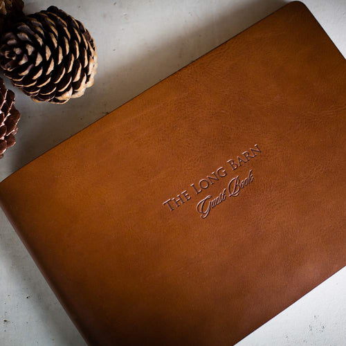 personalised brown leather guest book with blind debossed lettering by Hartnack and co
