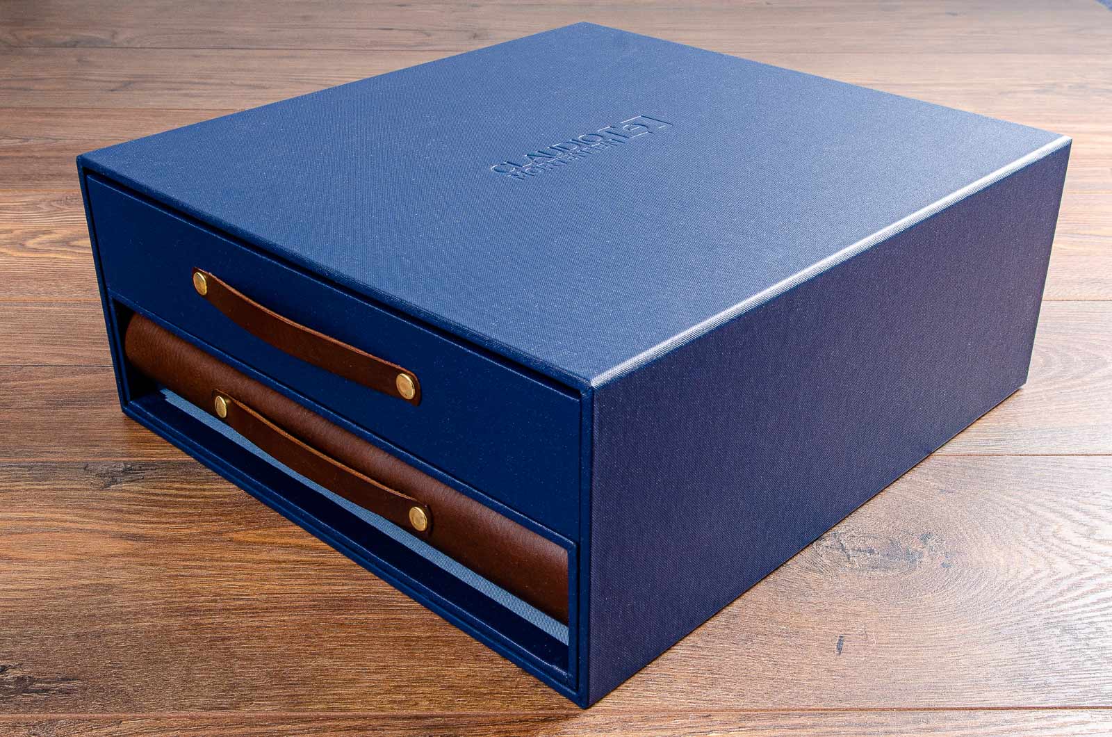 Portfolio box with drawer and leather portfolio book. Products are double slipcase with drawer and leather screw post binder. Personalisation is blind deboss on box cover