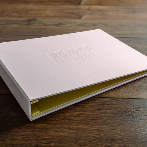 High quality A3 photographers portfolio book personalised in white book cloth in a landscape format with branded logo embossed on the cover