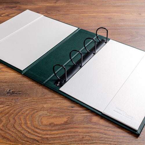 large custom made personalised file with black ring binder mechanism and contrasting inner cover with pockets custom made by Hartnack & Co. 