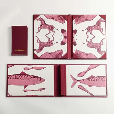 Two open menu covers in PU leather with pink animal illustrations on a white background