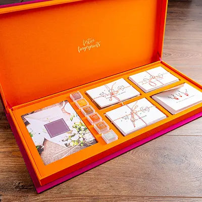 custom made luxury presentation box in orange and pink with gold foil personalisation
