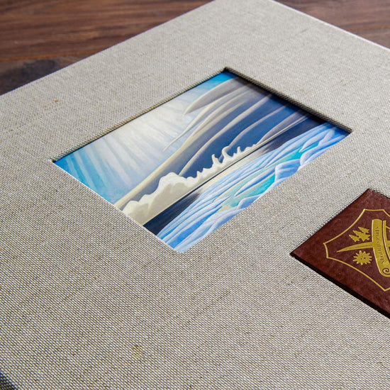 Cut out window in the cover of a custom made album with an image behind it 