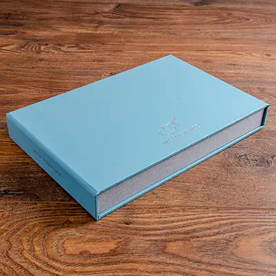 Custom made villa guest manual box file in blue buckram and personalised foil embossing
