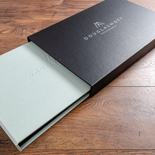 Luxury presentation binder in green fabric sliding into a black personalised slipcase