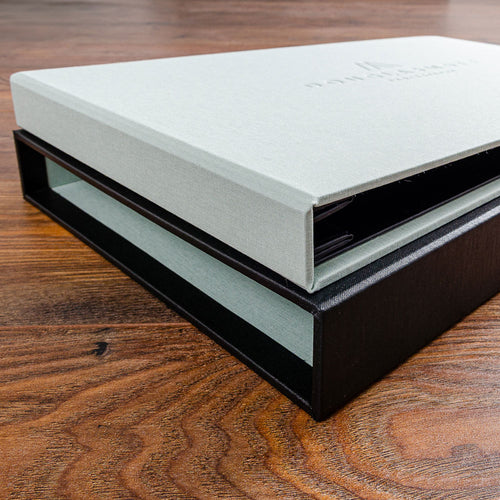 close up photo of green fabric quality binder on black slipcase