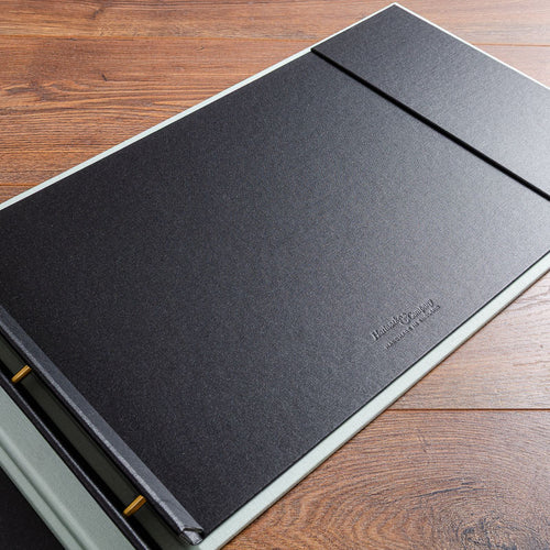 Hartnack and Company logo stamped into the cover of a landscape portfolio book