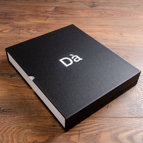 black slipcase box with white foiled logo on cover