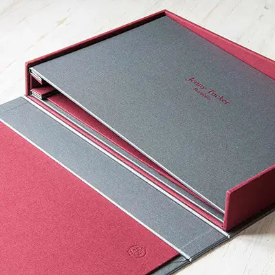 silver buckram screw post binder with red personalised cover sitting in clamshell box - Photographers & Designers, Hidden Screwpost Binders, Drop Back Boxes, All Screw Post Binders, All Clamshell Boxes