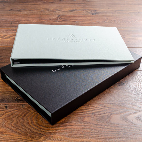 luxury landscape screw post presentation binder for photographer in green fabric with blind embossed cover on a black fabric slipcase