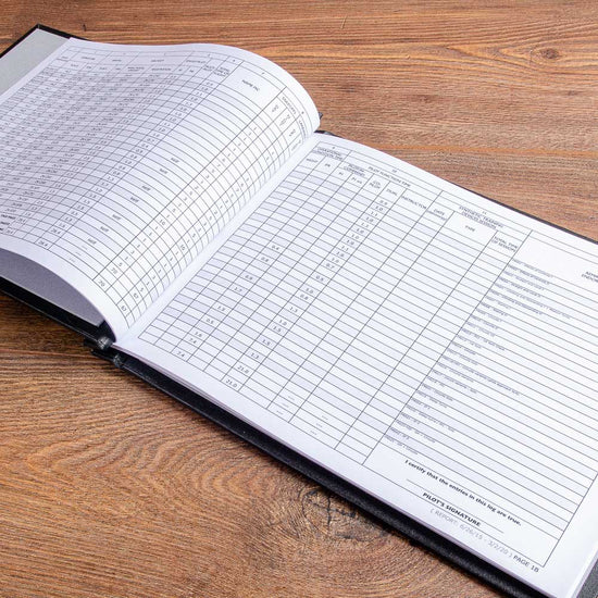 pilot logbook pages inside a screw post binder