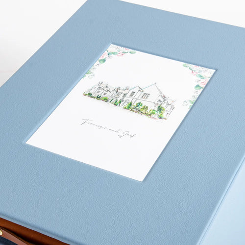 Inset recess in the cover of a leather box inside which is the cover of a wedding invitation, the box is the top of a wedding keepsake box