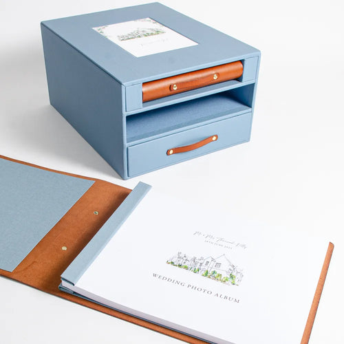 Luxury leather wedding album laying open in front of custom made slipcase box with guest book and drawer for wedding keepsakes