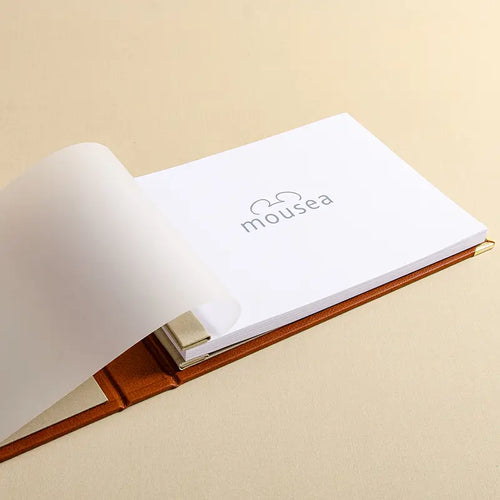The cover sheet of a personalised guest book with the first page printed with a logo on it