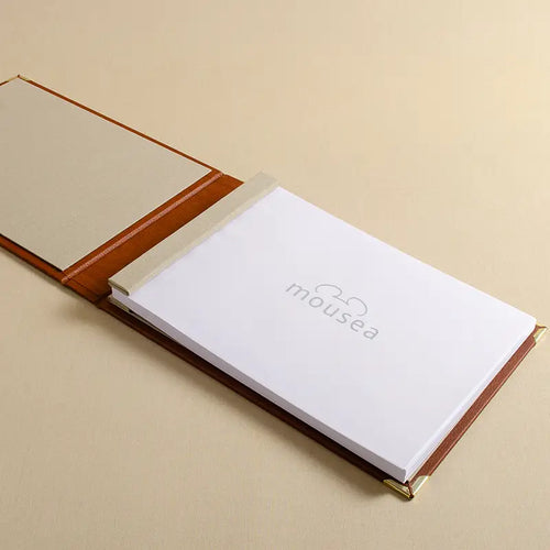 A high quality brown faux or vegan leather guest book that uses screw post binder mechanism by hartnack and co
