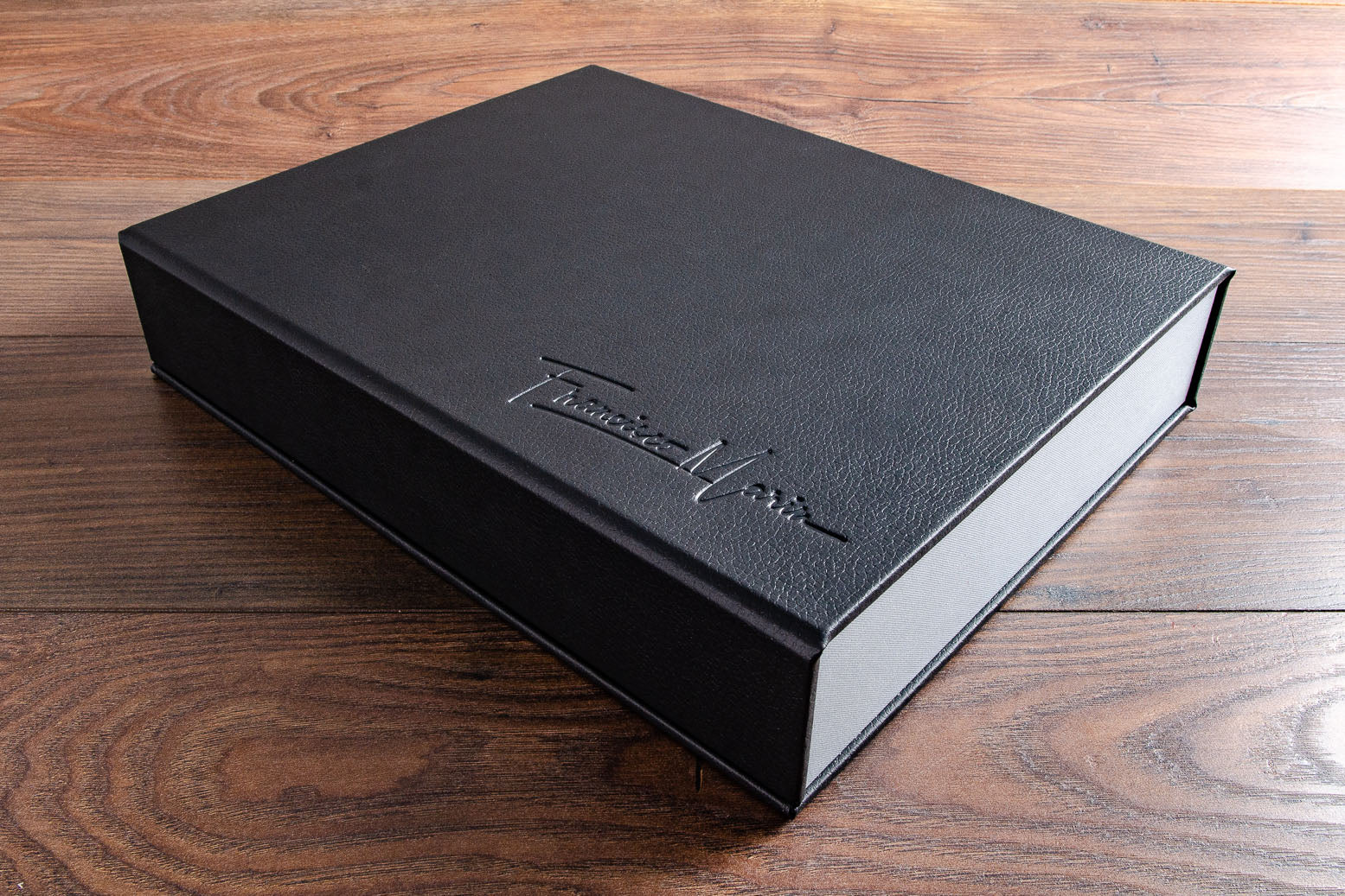Photographers A4 Portfolio Box. Product is H&Co drop back clamshell box covered in black faux leather personalised with blind embossed stamping