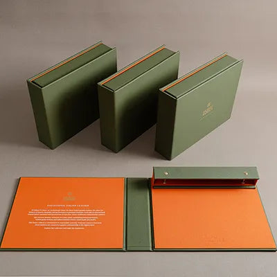 Green leather covered fabric swatch book with screw post binding and gold foil embossed cover and personalised inner cover