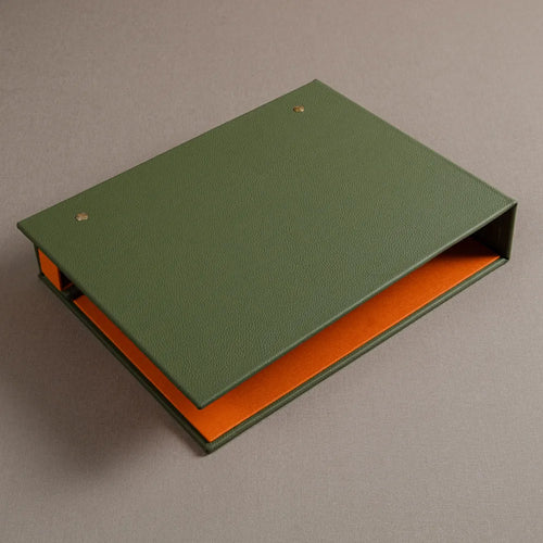 Back cover of a green leather covered screw post swatch book