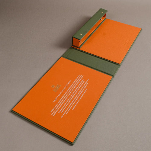 Orange book cloth inner cover of a screw post swatch book with white foil embossed personalisation