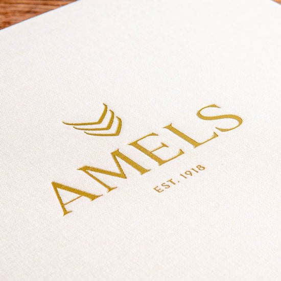 close up of gold foil embossed logo on the cover of a presentation box by Hartnack and Co