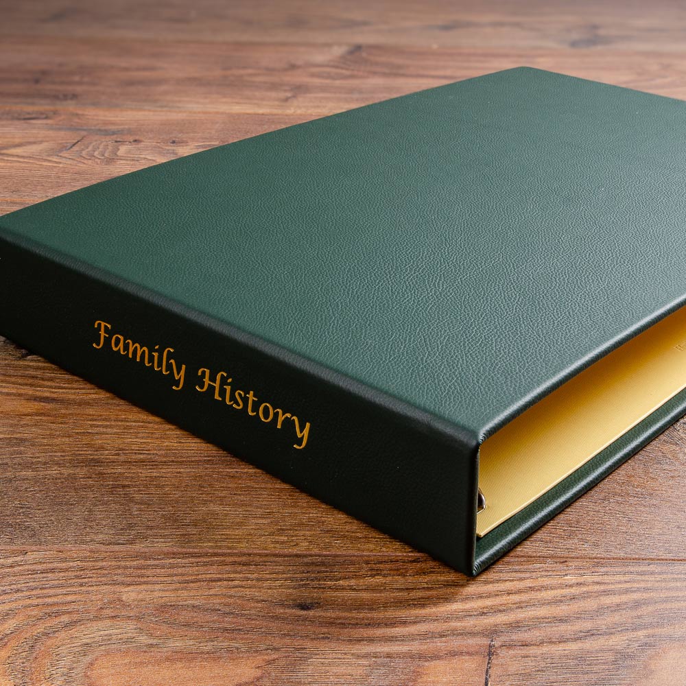 green and yellow leather family history album on brown wood - Gallery image 3