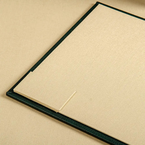 A close up of a pocket inset into the cover of a luxury ring binder 
