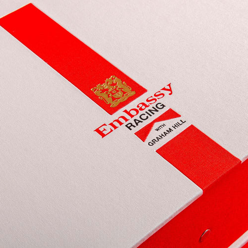 the personalisation details on the cover of a box file with red ribbon and gold foil embossed. Also a red foil logo and and black foil writing