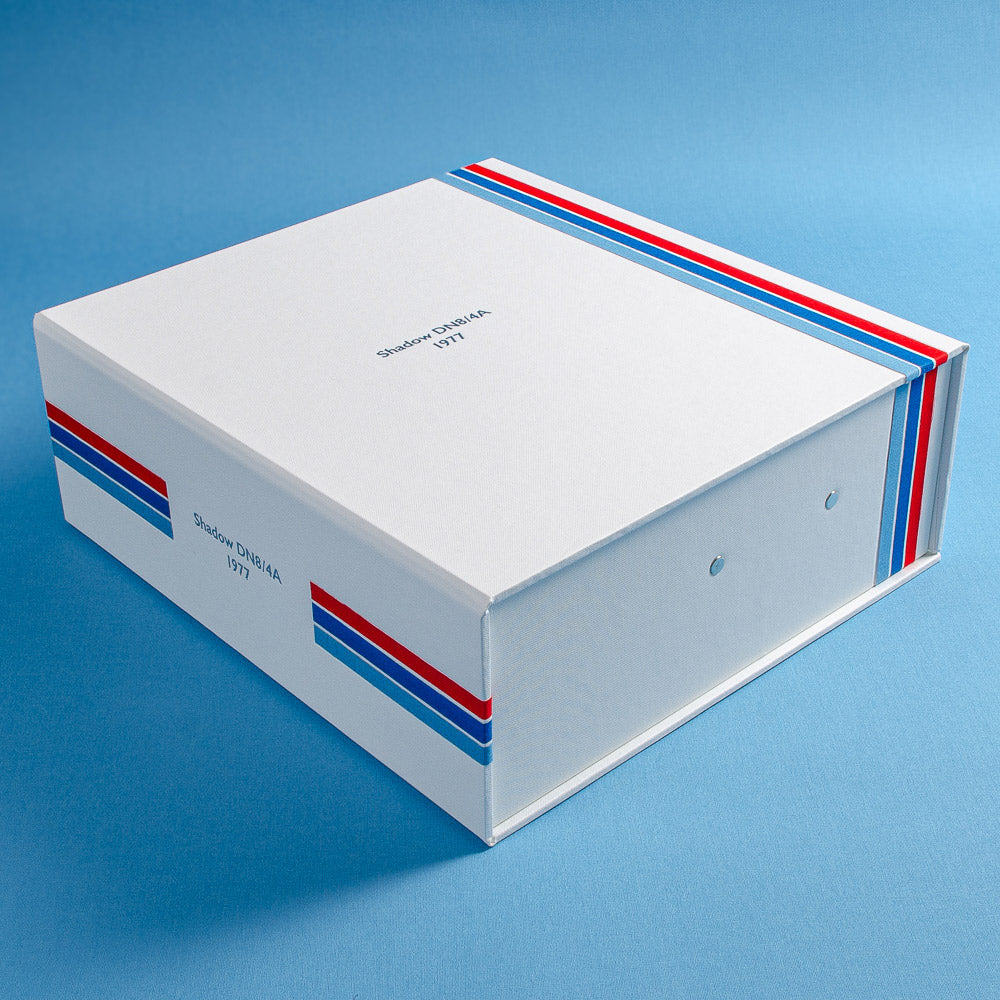 custom made box file in white cloth with red and blue pin stripes and the details a classic F1 car embossed in silver on the cover and spine - Vehicles, Box Files