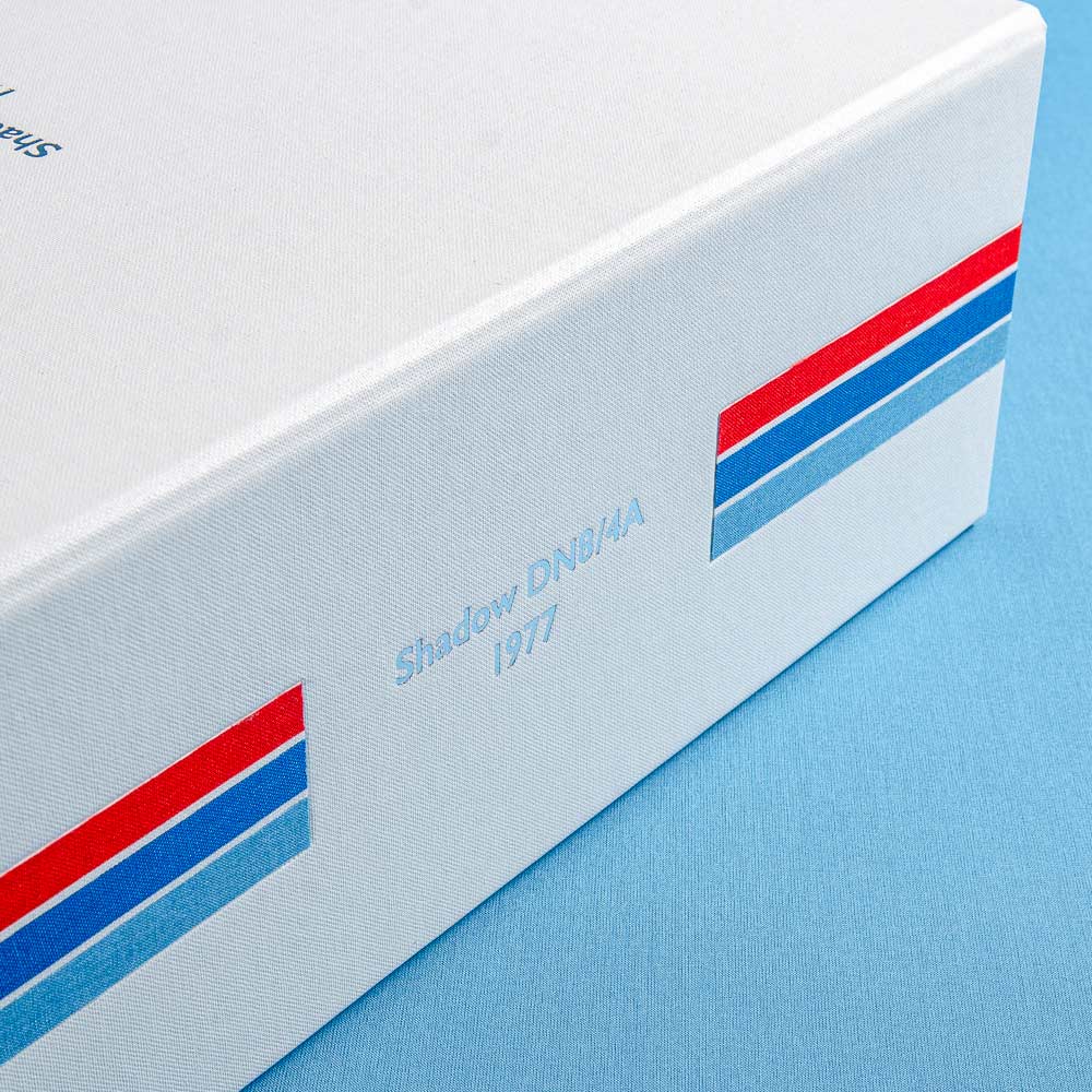 the spine of a box file in white buckram cloth with red and blue stripes and the details of a car personalised in silver foil  - Gallery image 3