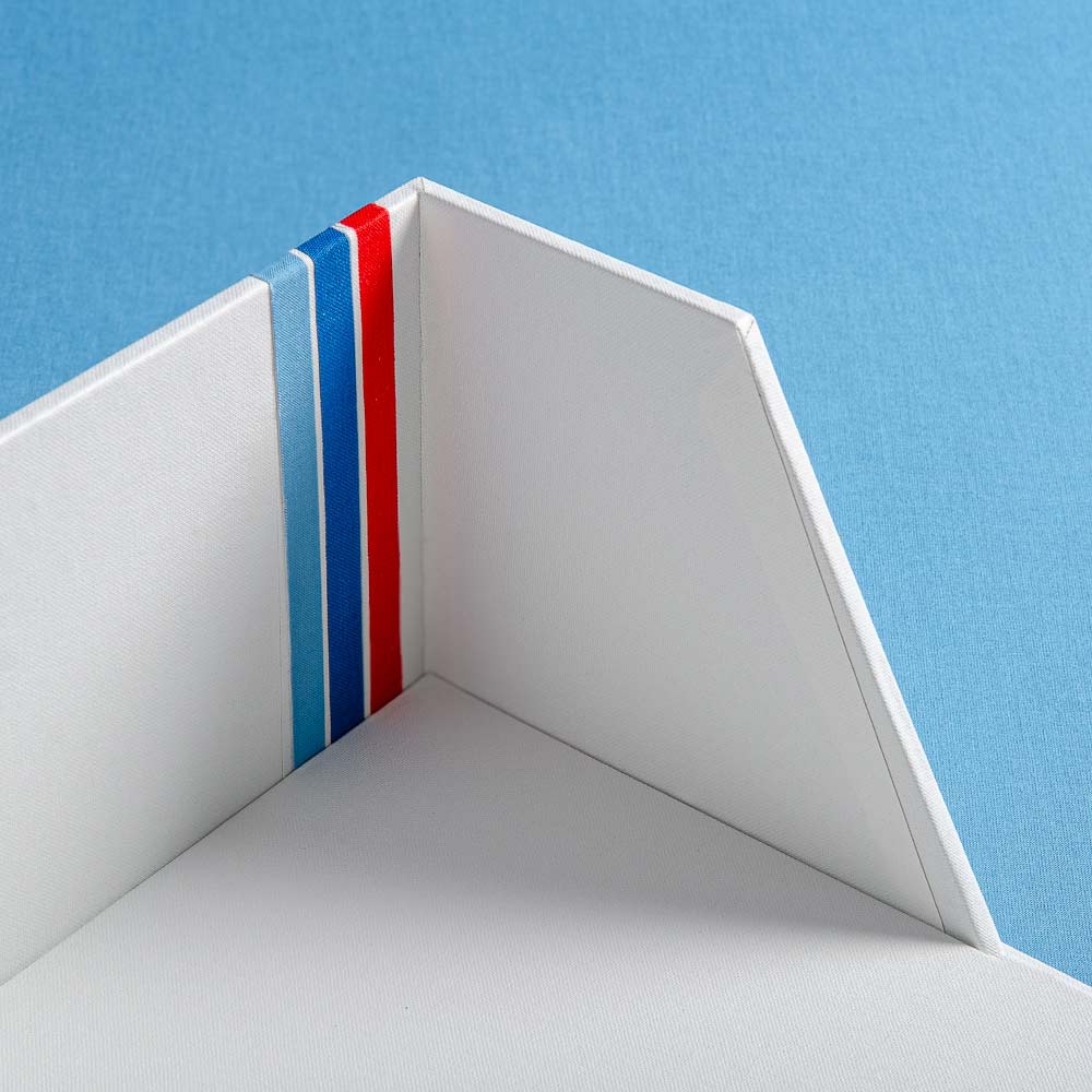 details of the corner of a box file with a V cut out and three stripes inset into the side of the clamshell box - Gallery image 6