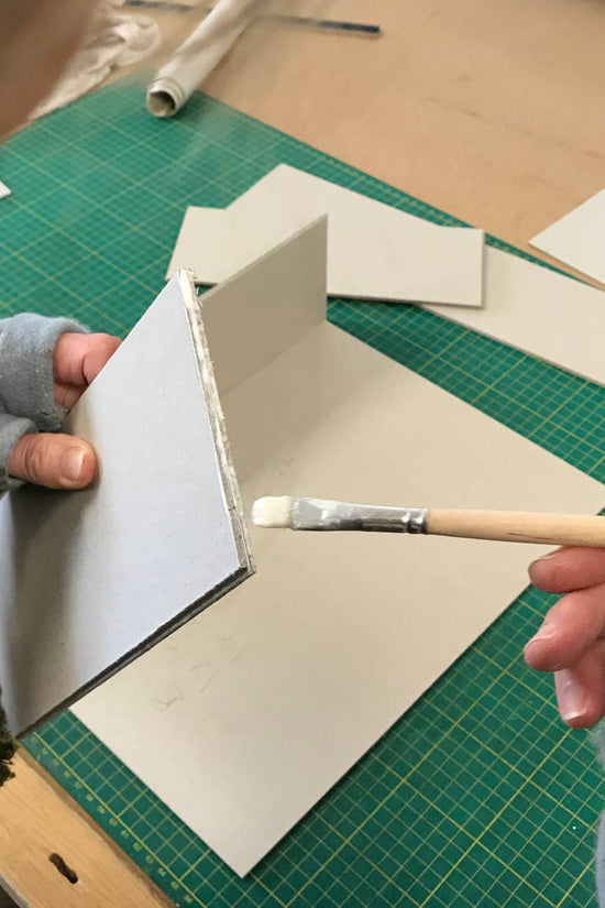 detail shot of glue being added to a step jointed board used for making a bespoke clamshell box