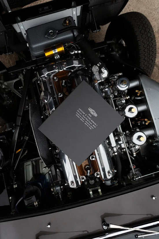 custom made personalised vehicle history file sitting on jaguar e-type engine