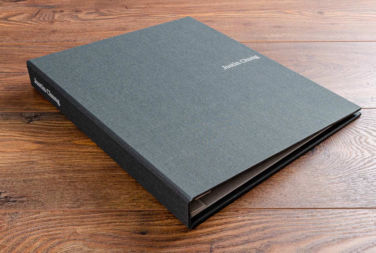 Photography portfolio book. Size 11x14. Product is a case bound screw post binder. Material cover is Corfe book cloth. Personalisation is white foil embossing