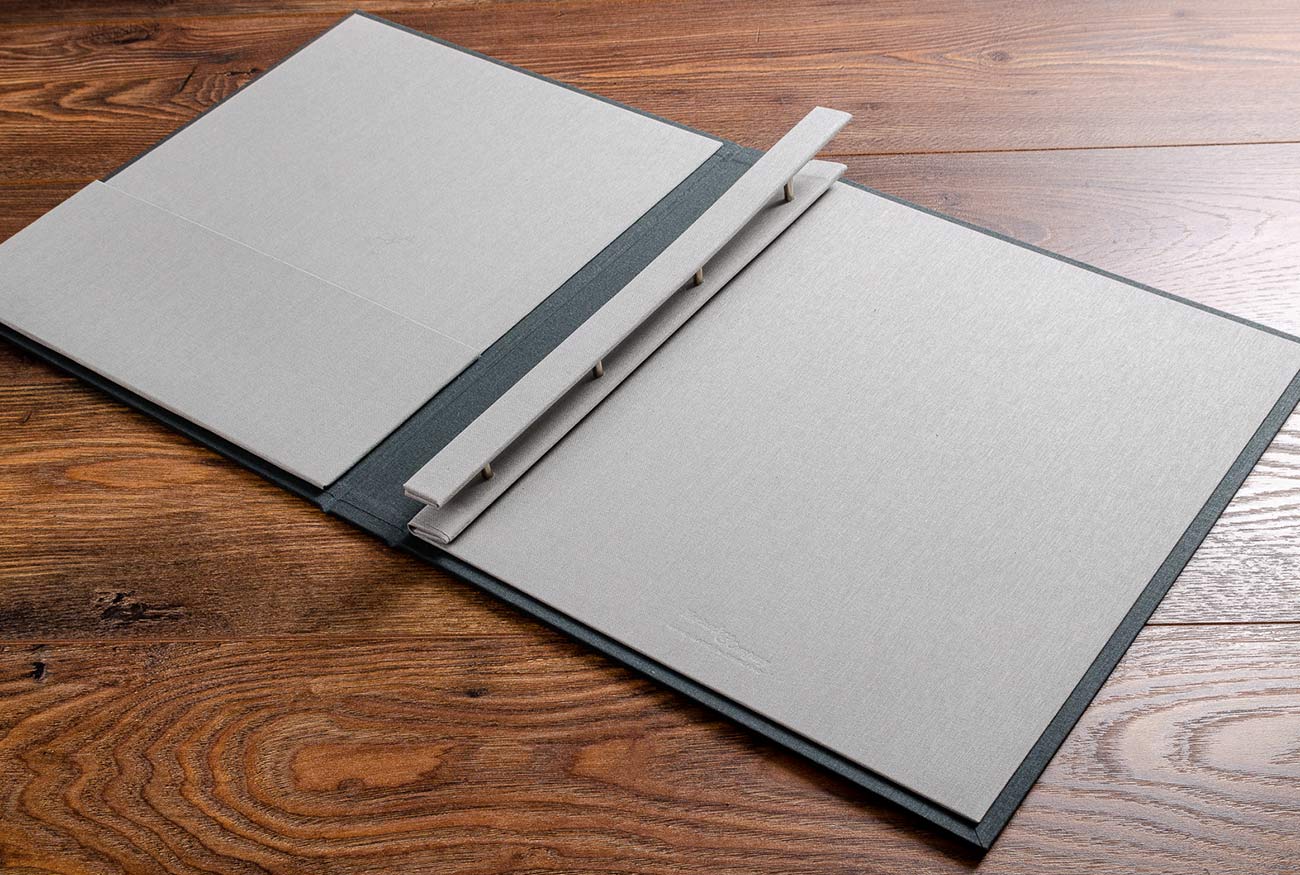 Photographers portfolio book sized to 11x14 prints. Screw post binder mechanism. Inner cover material is stone book cloth