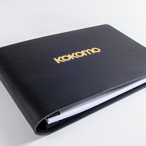 black leather book with gold foiled embossed logo on the cover custom made by hartnack and company