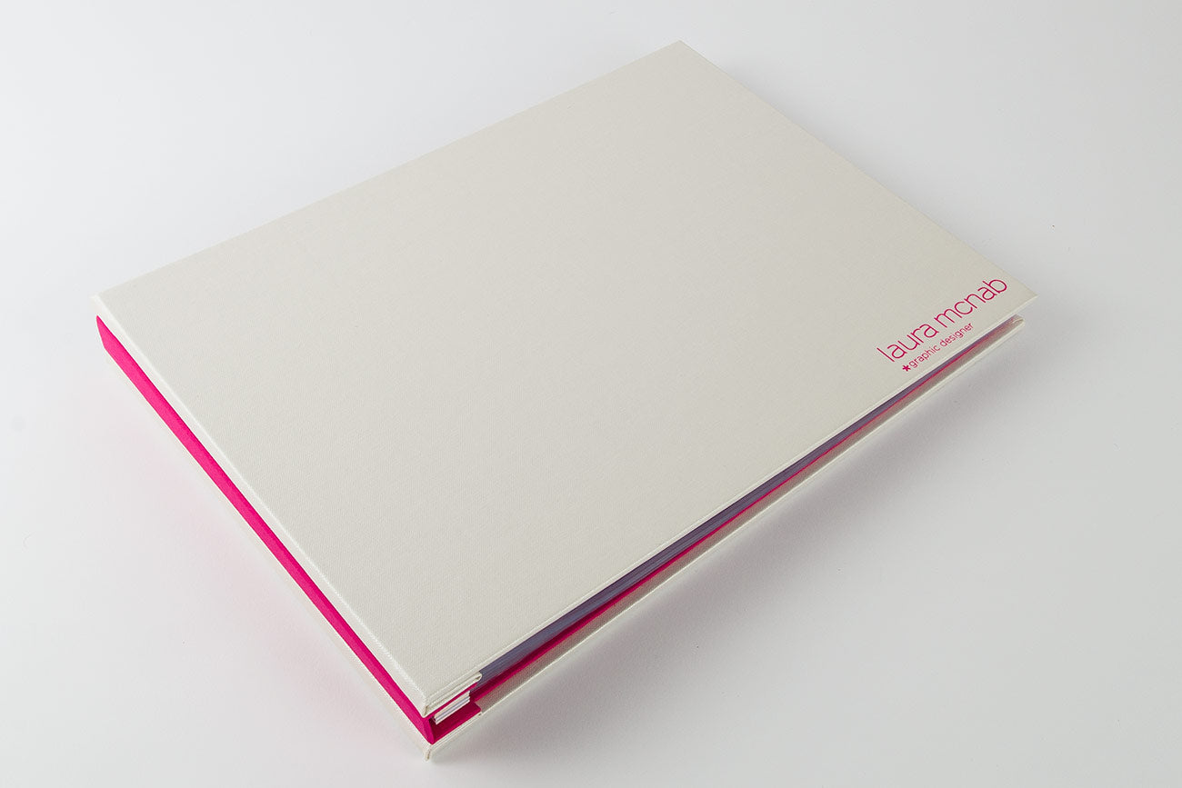 Graphic designers A4 landscape portfolio book in white and pink