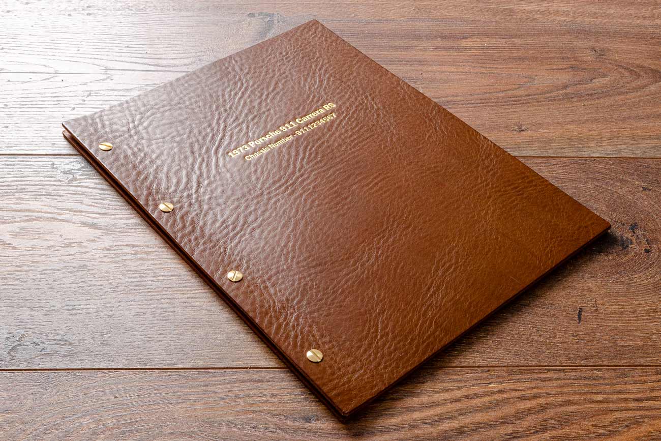 Brown leather A4 binder with gold foil embossing on the cover.